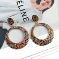 A pair of colourful cartoon style alloy earrings with large round pendant drops for women.