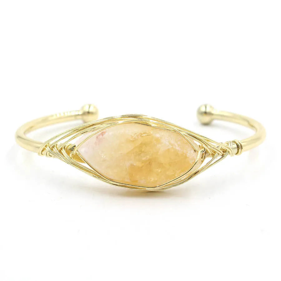 Natural raw gemstone bracelet in amorphous winding shape with simple opening, shown in amethyst crystal colour.
