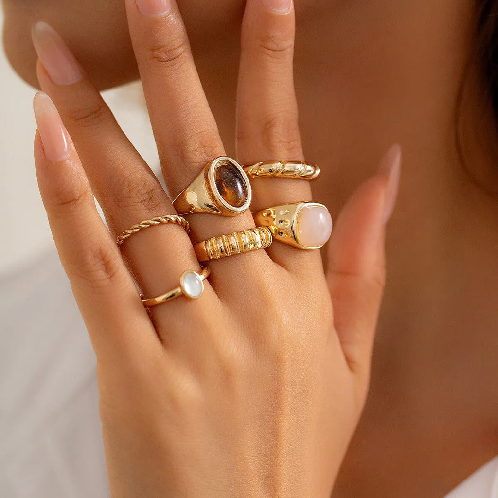 Six irregular geometric alloy rings in light gold electroplated finish arranged as set