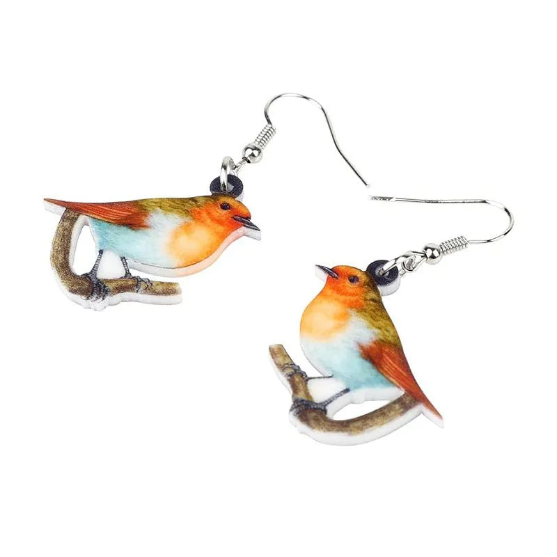 Close-up of women's acrylic earrings with a blue titmouse bird pendant and geometric snake motif design.