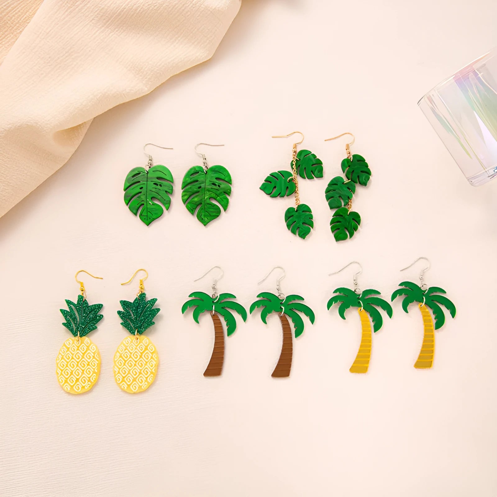 Close-up of acrylic drop earrings with a coconut artocarpus design on alloy hooks, showing one of five colour styles.