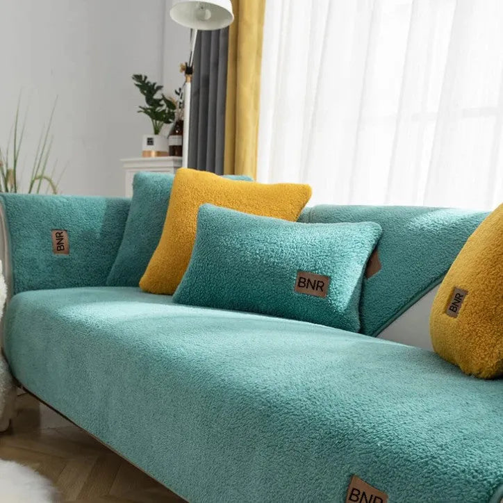 Solid colour lambswool sofa cover on a couch, showing cloth liner and neat fit.