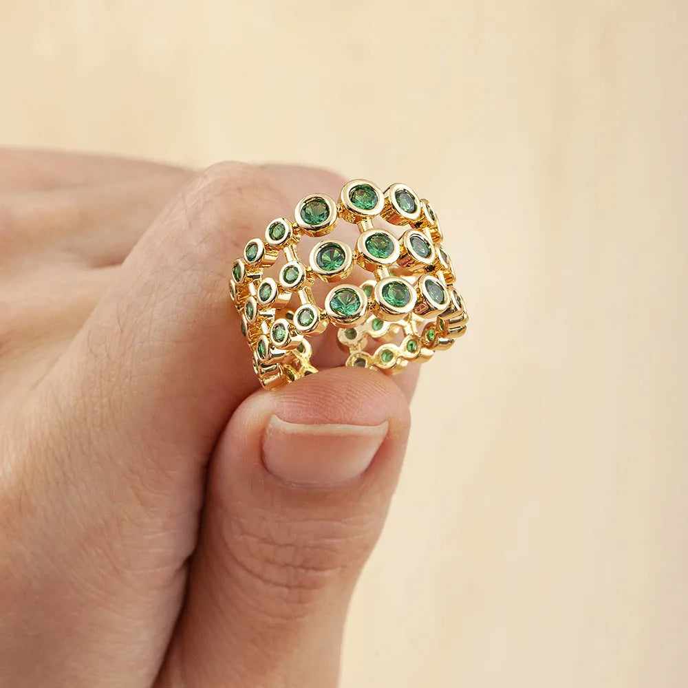Wide gold-plated copper ring with a large cluster of green zircon stones.