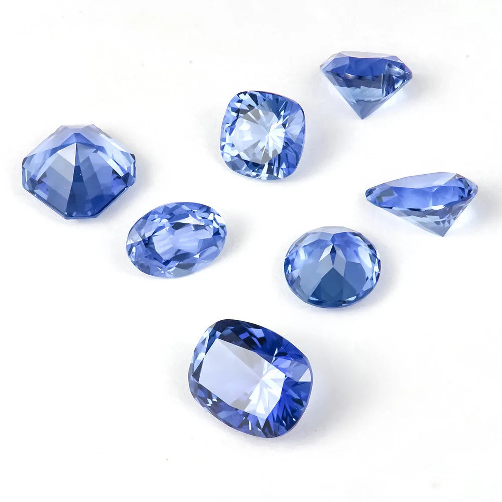 Royal blue cut gemstone in a heart shape on a plain background.
