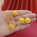 Gold-plated three-piece jewellery set showing necklace with floral pendant, matching earrings, and ring on a water wave chain.