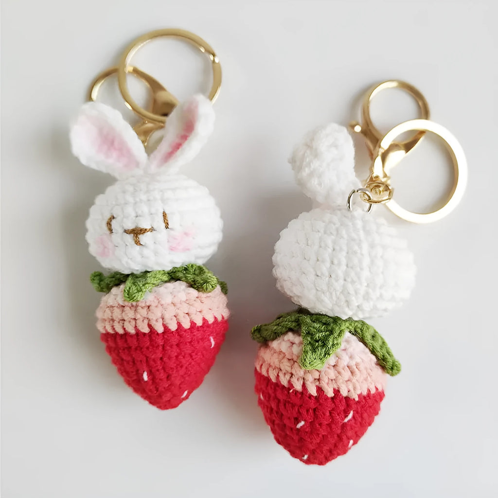 Hand-woven white wire rabbit pendant with strawberry pattern and attached key chain