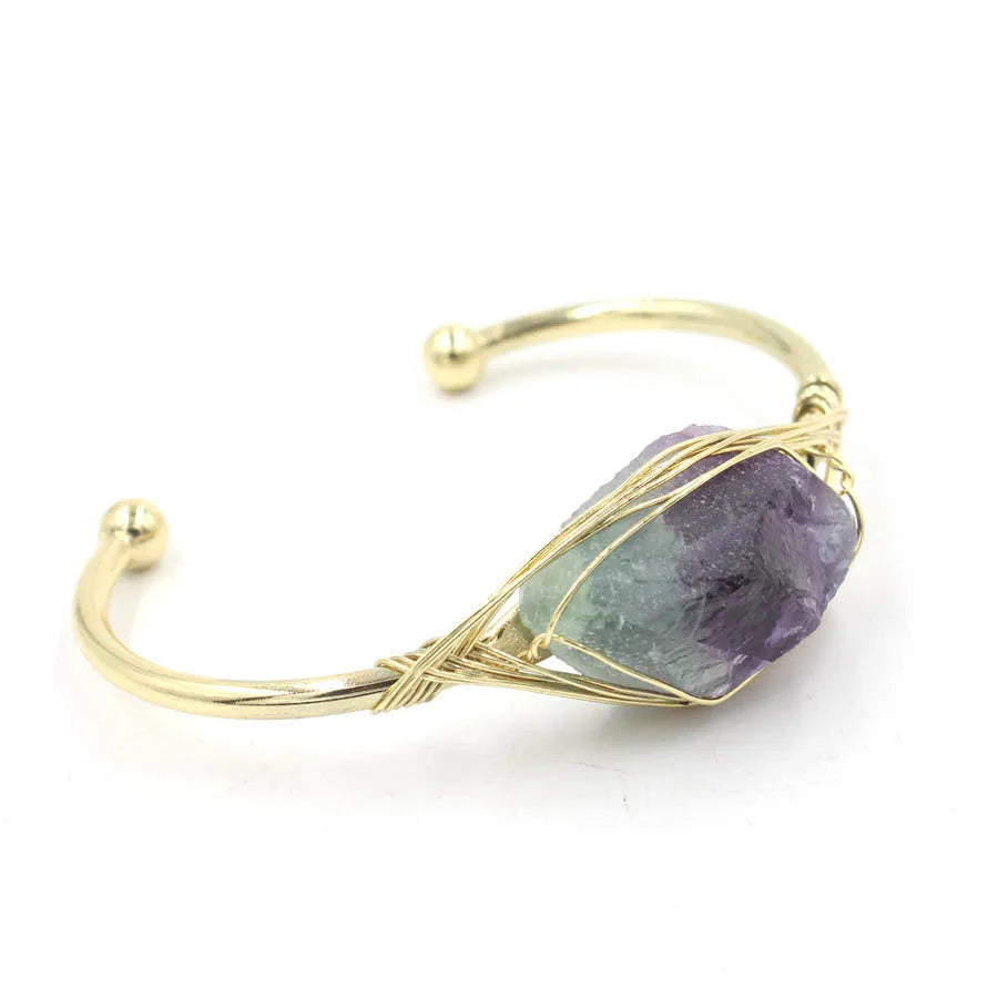 Natural raw gemstone bracelet in amorphous winding shape with simple opening, shown in amethyst crystal colour.