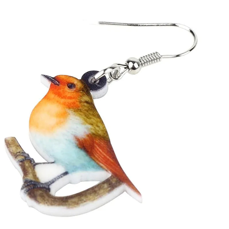 Close-up of women's acrylic earrings with a blue titmouse bird pendant and geometric snake motif design.