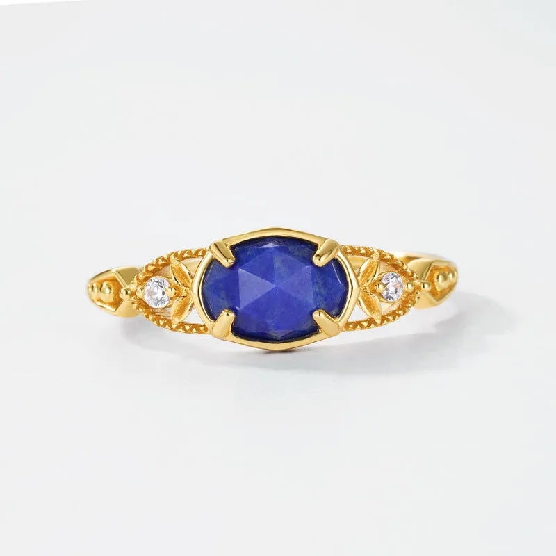 Japanese style silver alloy ring with elliptical geometric shape and blue lapis lazuli stone.