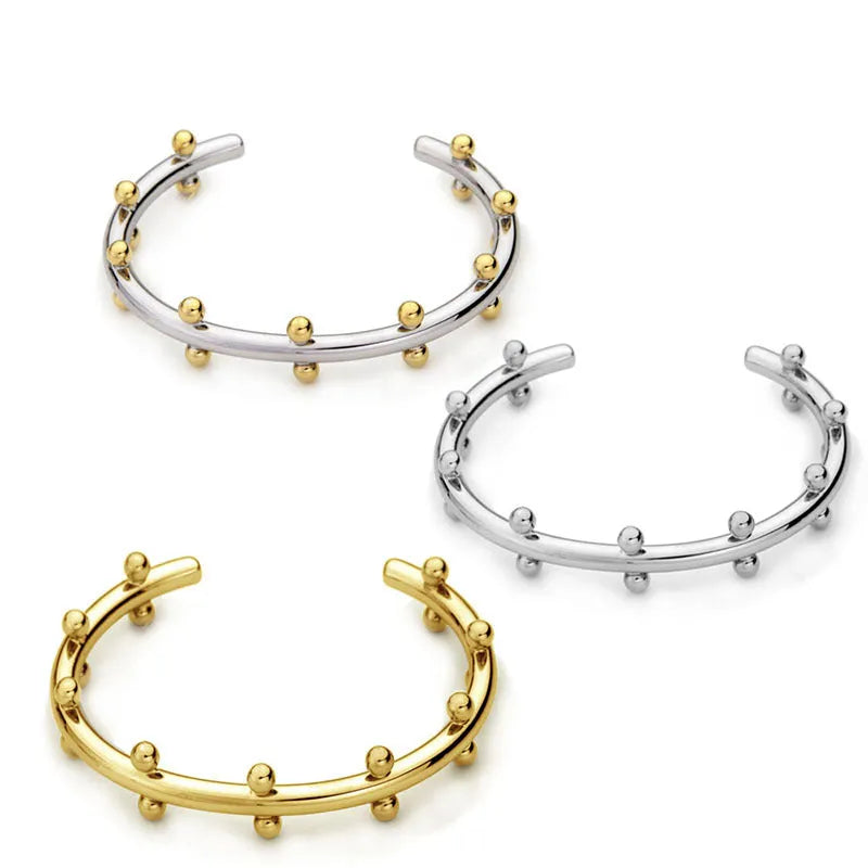 Stainless steel C-shaped bracelet with rivet bead texture in gold steel colour option