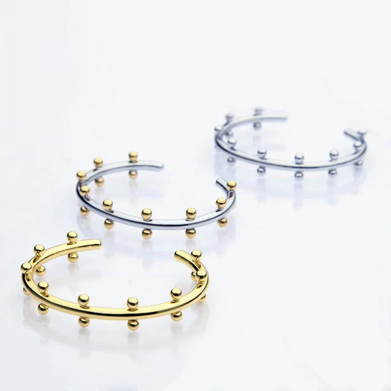 Stainless steel C-shaped bracelet with rivet bead texture in gold steel colour option