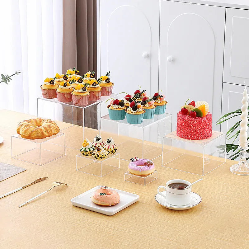 White plastic cube-shaped dessert display stands arranged on countertop for cake presentation