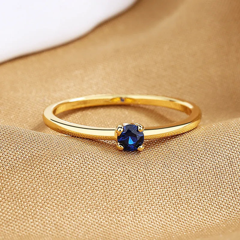 Copper geometric women's ring with a single diamond and fine circle, shown in blue.