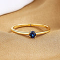 Copper geometric women's ring with a single diamond and fine circle, shown in blue.