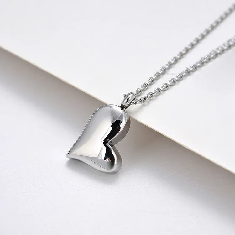 Silver curved peach heart pendant on stainless steel necklace with adjustable chain