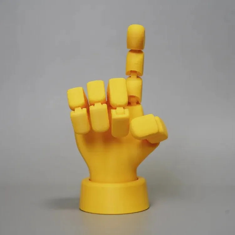 Yellow PLA movable joint hand prop figurine on a white background.