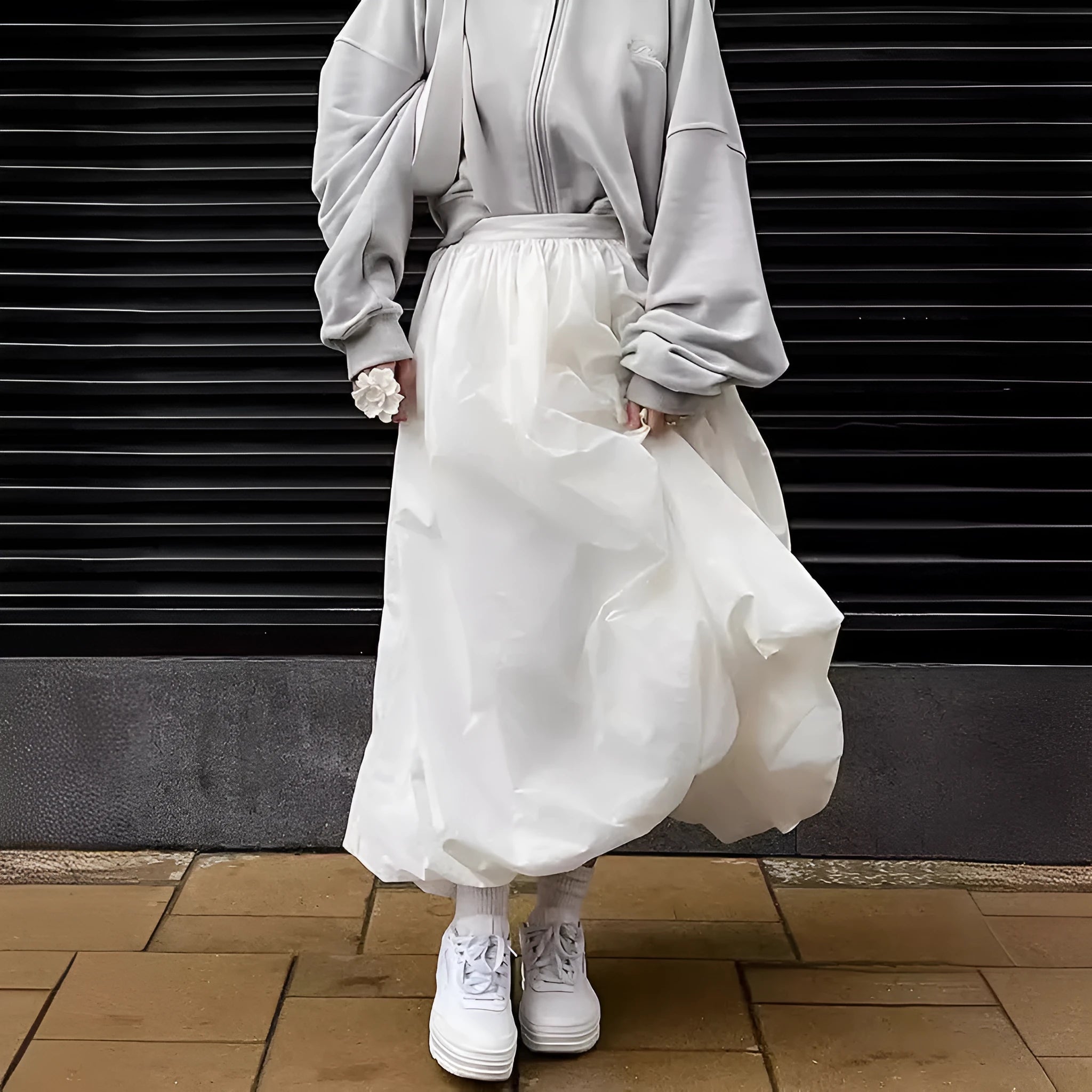 Women's long solid colour cotton skirt in black on a hanger.