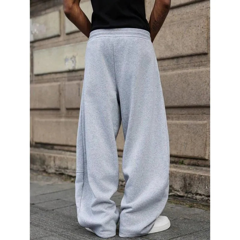 Men's high-waisted straight-leg cropped trousers in a neutral colour on a model