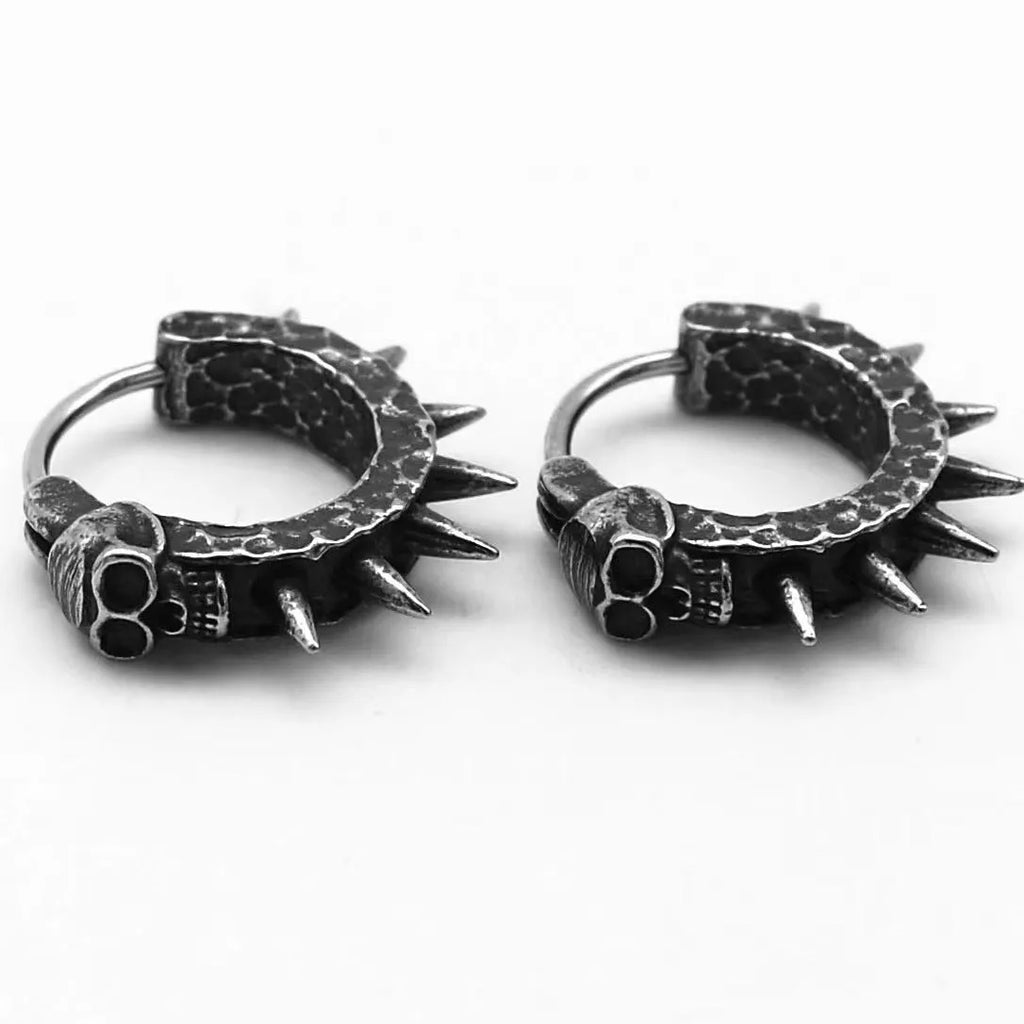 Close-up of black zinc alloy motorcycle-shaped earrings with copper-plated plastic punk details.
