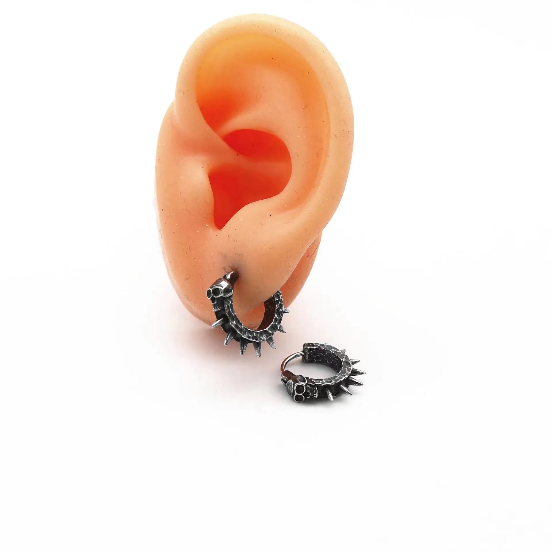 Close-up of black zinc alloy motorcycle-shaped earrings with copper-plated plastic punk details.