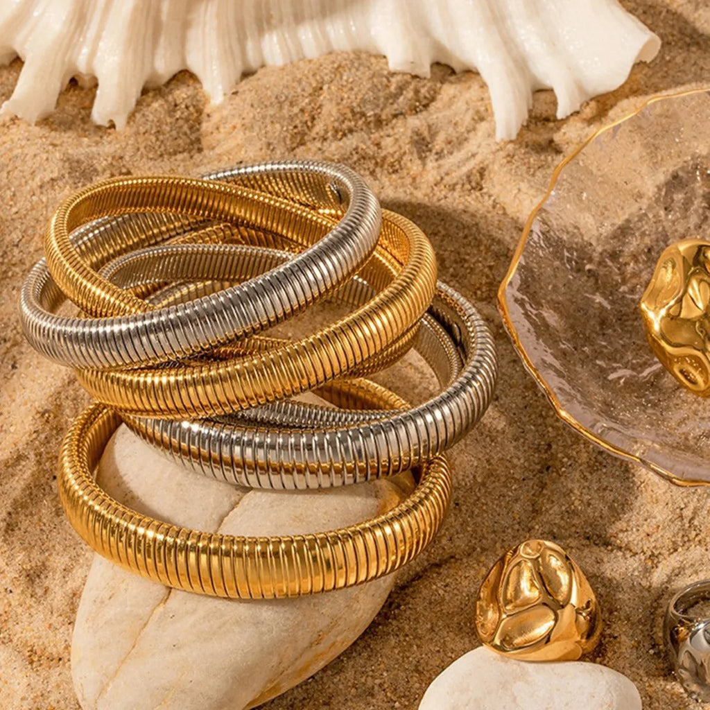 Women's titanium steel bracelet with vertical stripe ring pattern in gold colour