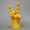 Yellow PLA movable joint hand prop figurine on a white background.