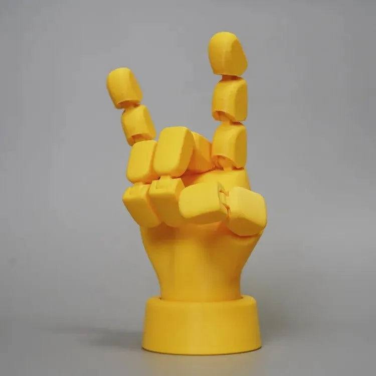 Yellow PLA movable joint hand prop figurine on a white background.
