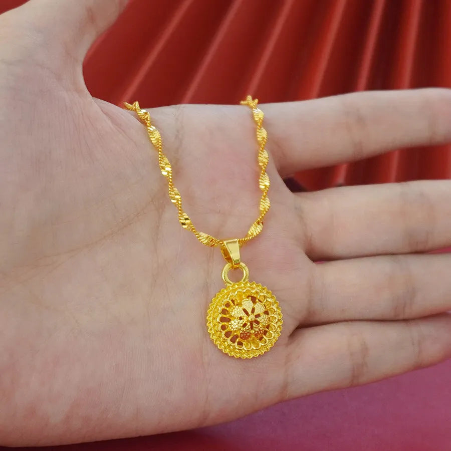 Gold-plated three-piece jewellery set showing necklace with floral pendant, matching earrings, and ring on a water wave chain.