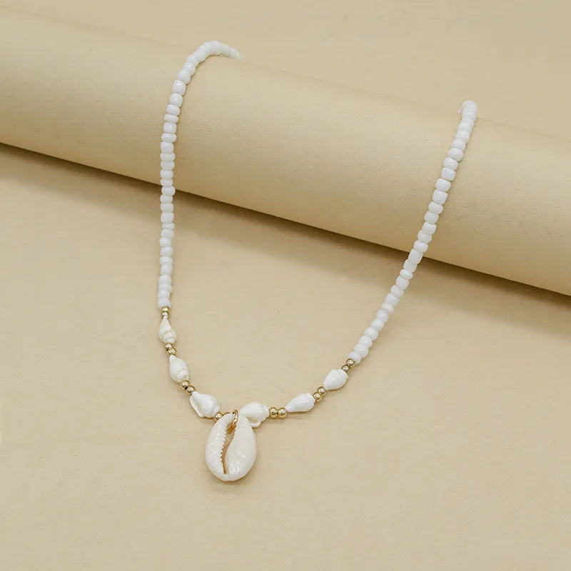 White conch shell mother-of-pearl pendant necklace on a silver electroplated chain for women.