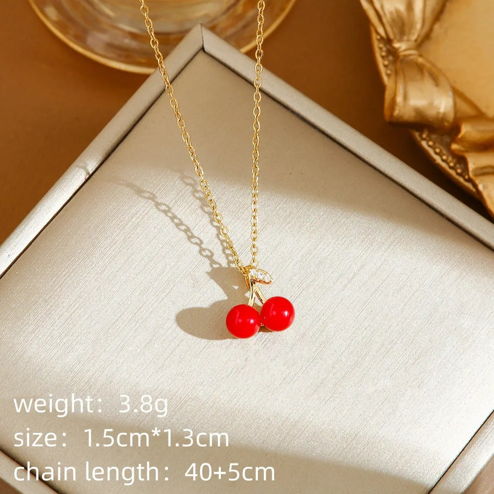 Women's titanium steel necklace with small red cherry, strawberry, and pepper charms on O-ring chain.