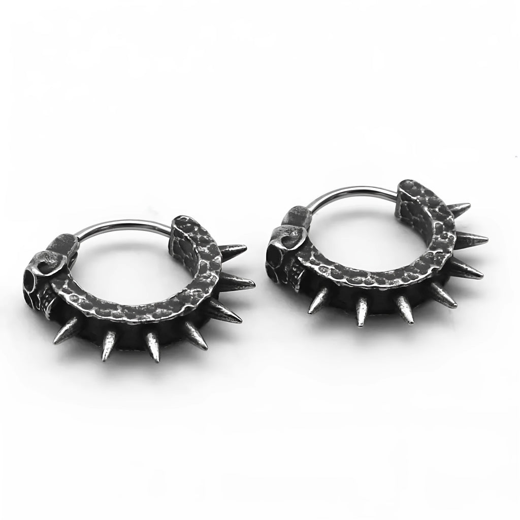 Close-up of black zinc alloy motorcycle-shaped earrings with copper-plated plastic punk details.