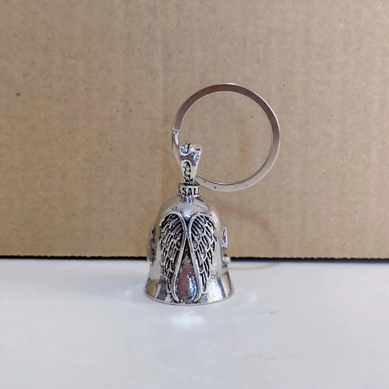 White vintage angel feather design on a zinc alloy necklace and matching keychain.