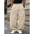 Men's high-waisted straight-leg cropped trousers in a neutral colour on a model