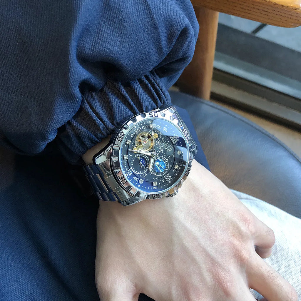 Men's silver case automatic mechanical watch with black starry luminous dial and leather strap.