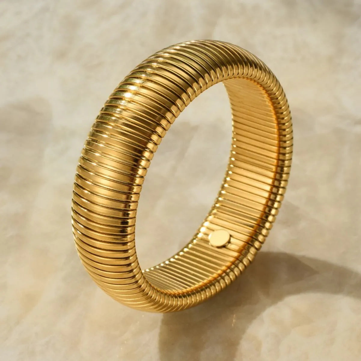 Women's titanium steel bracelet with vertical stripe ring pattern in gold colour