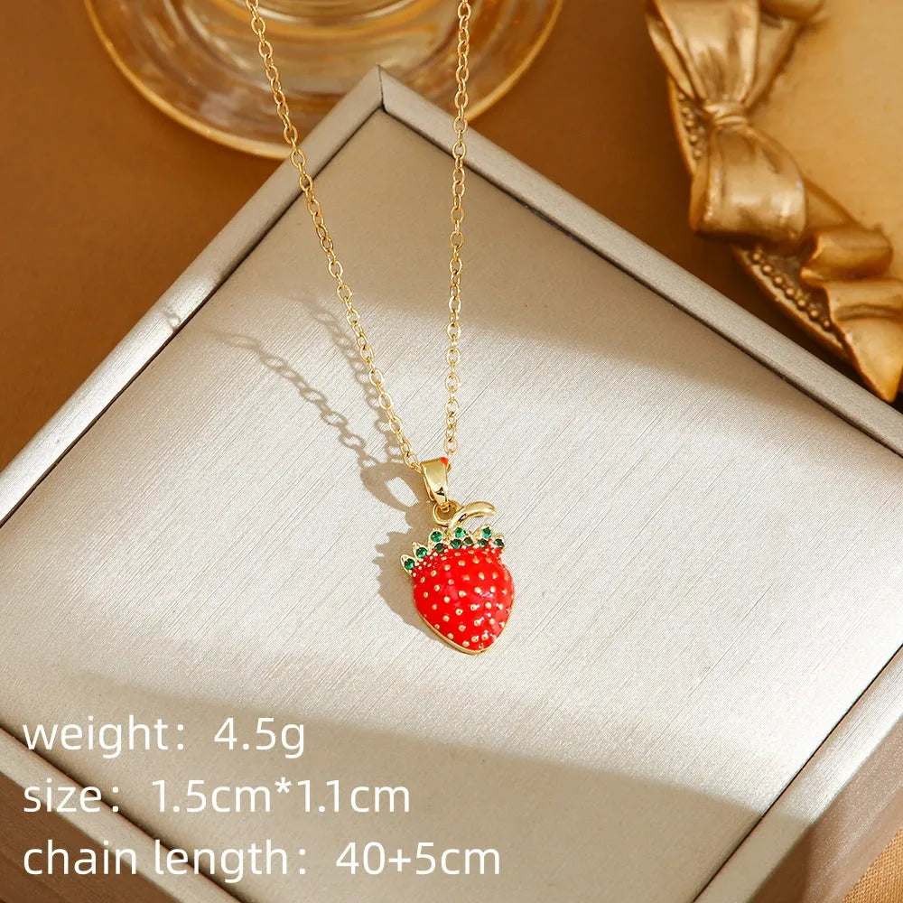 Women's titanium steel necklace with small red cherry, strawberry, and pepper charms on O-ring chain.