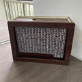Wooden retro digital coin bank with digital display on modern simple desk.
