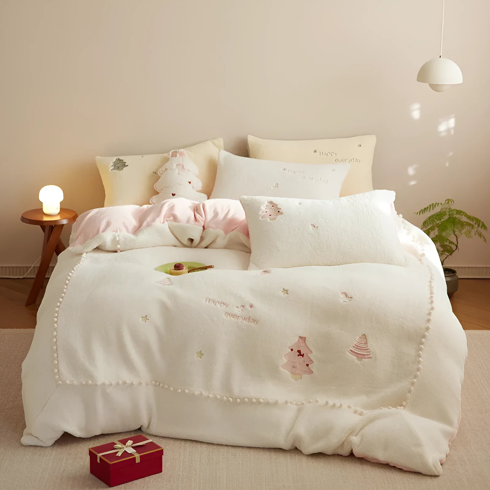 Winter milk fibre four-piece bedding set with green Christmas tree pattern on bed