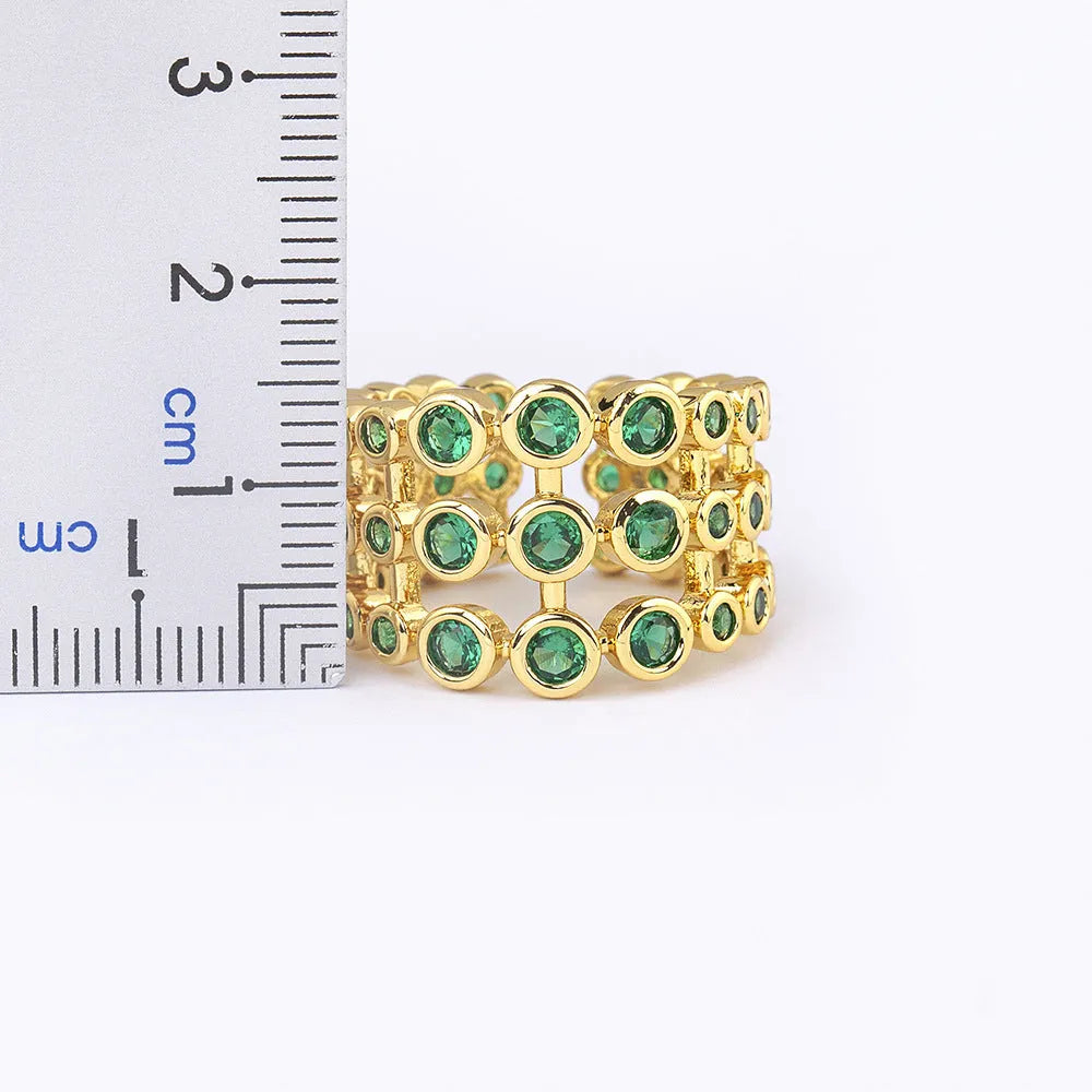 Wide gold-plated copper ring with a large cluster of green zircon stones.