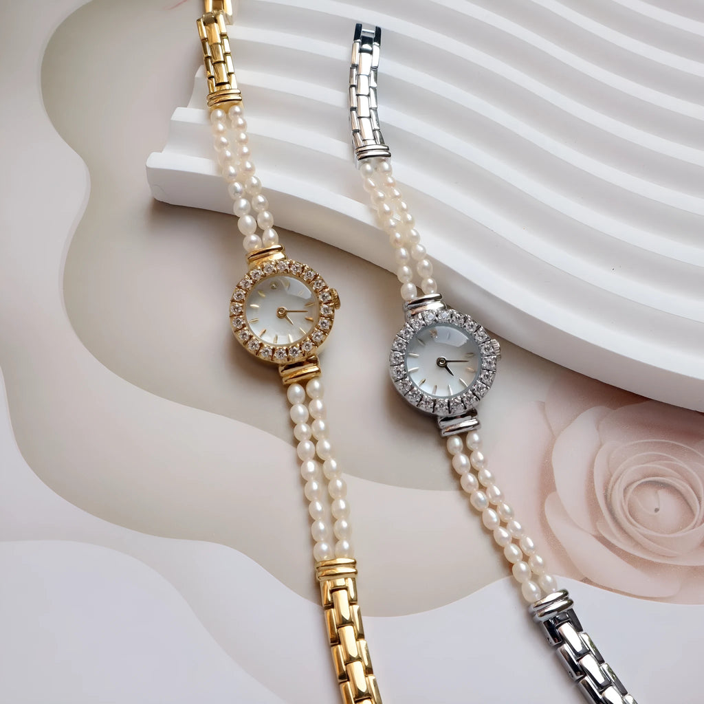 Women's light gold bracelet watch with freshwater pearls and an 18mm round dial.