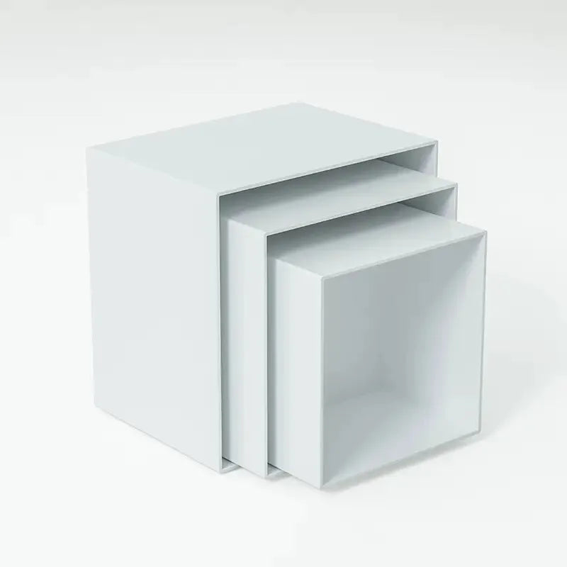 White plastic cube-shaped dessert display stands arranged on countertop for cake presentation
