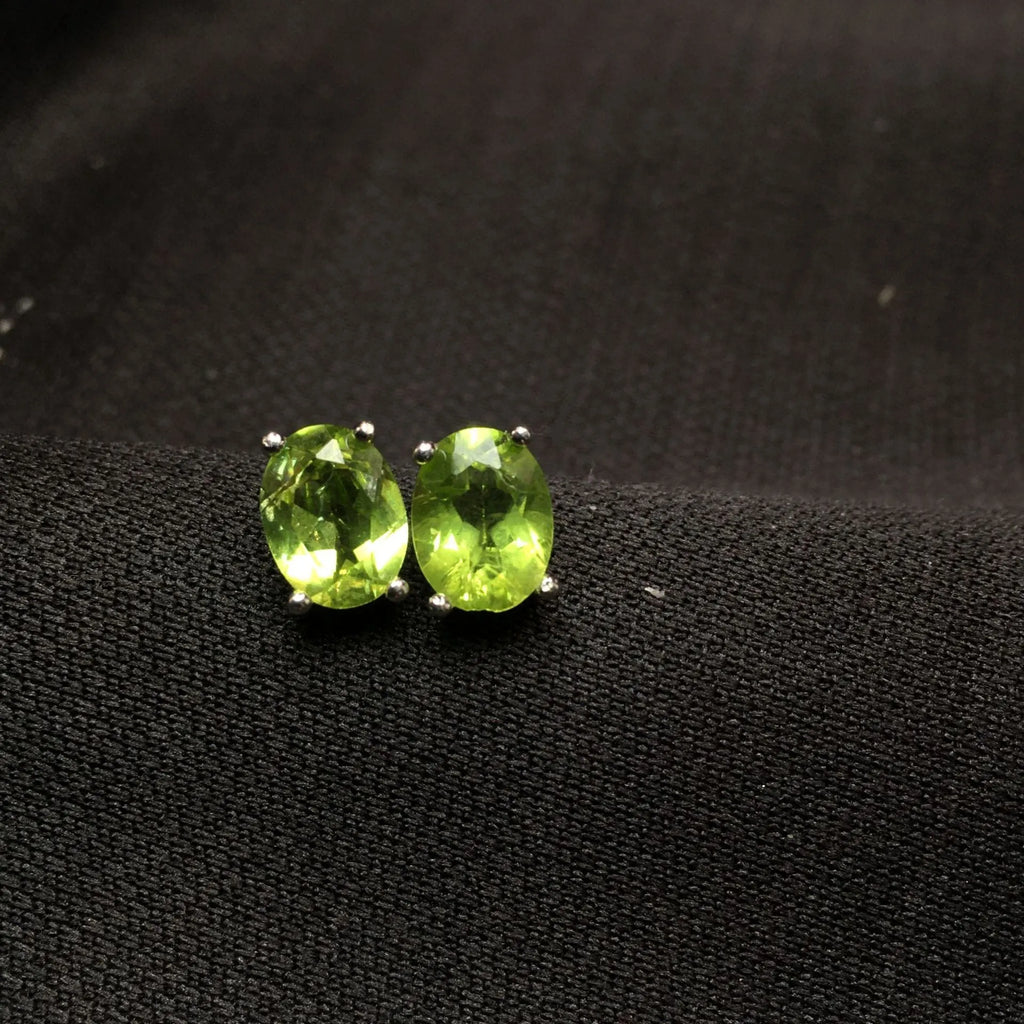 Natural grass green olivine faceted stud earrings in S925 sterling silver setting.
