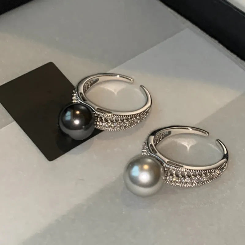 Geometric copper women's ring with adjustable opening and a black pearl detail.