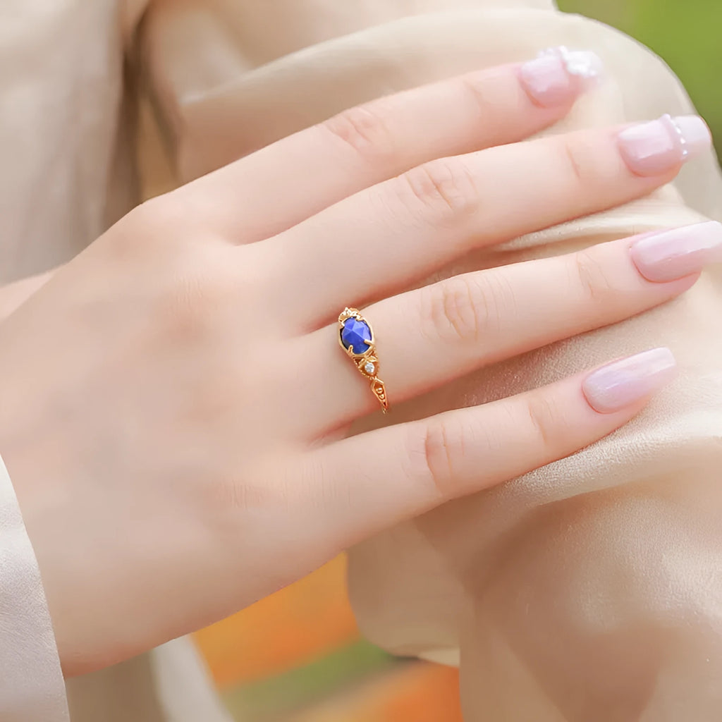 Japanese style silver alloy ring with elliptical geometric shape and blue lapis lazuli stone.
