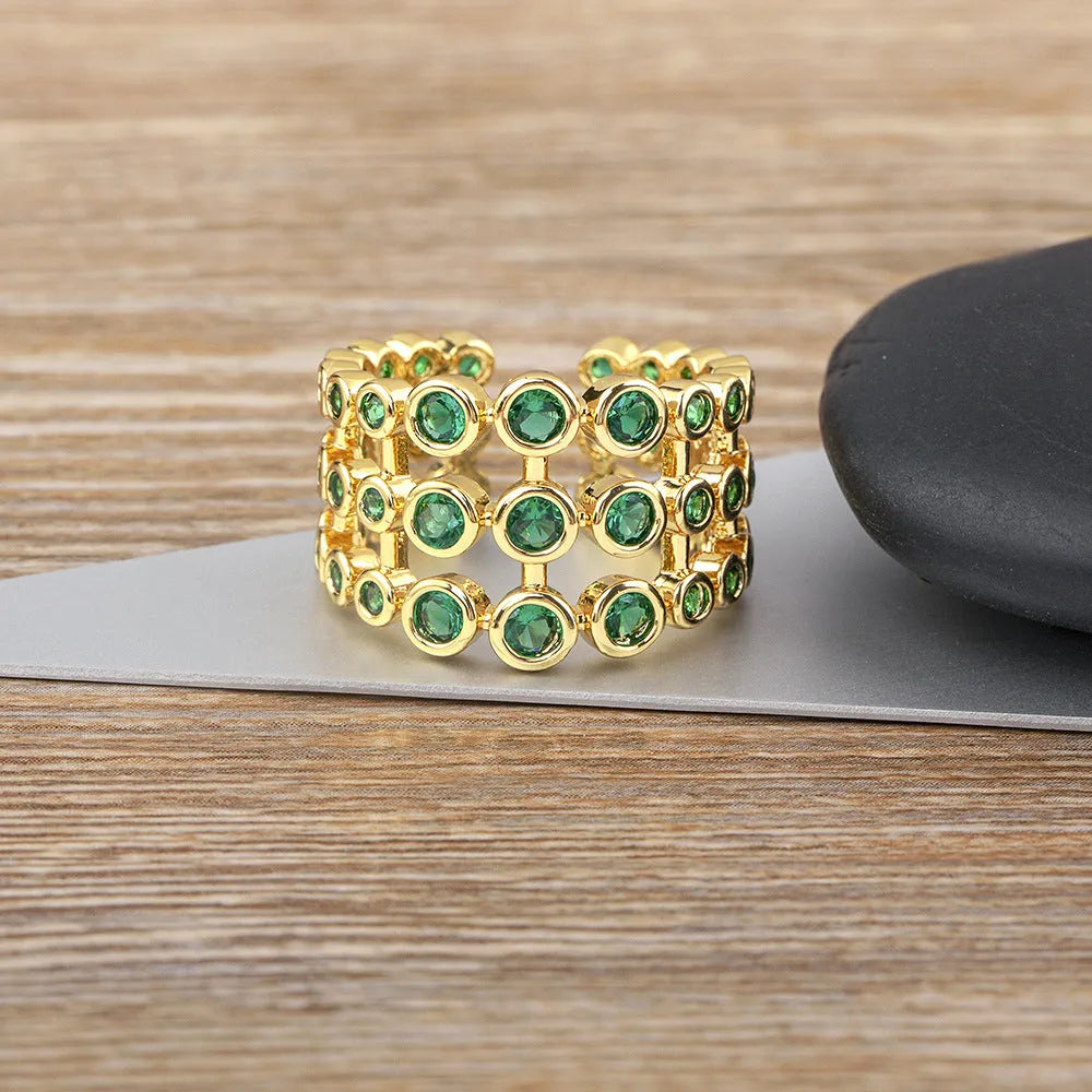 Wide gold-plated copper ring with a large cluster of green zircon stones.