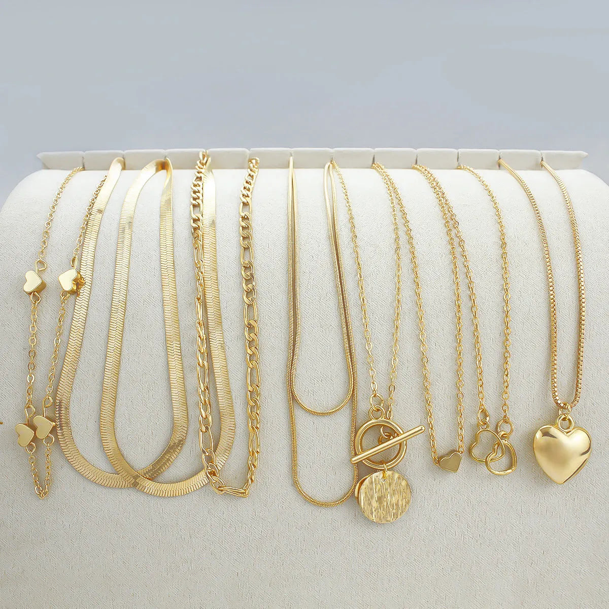 Gold electroplated women's necklace set with 10 alloy pendant pieces on snake bones chains