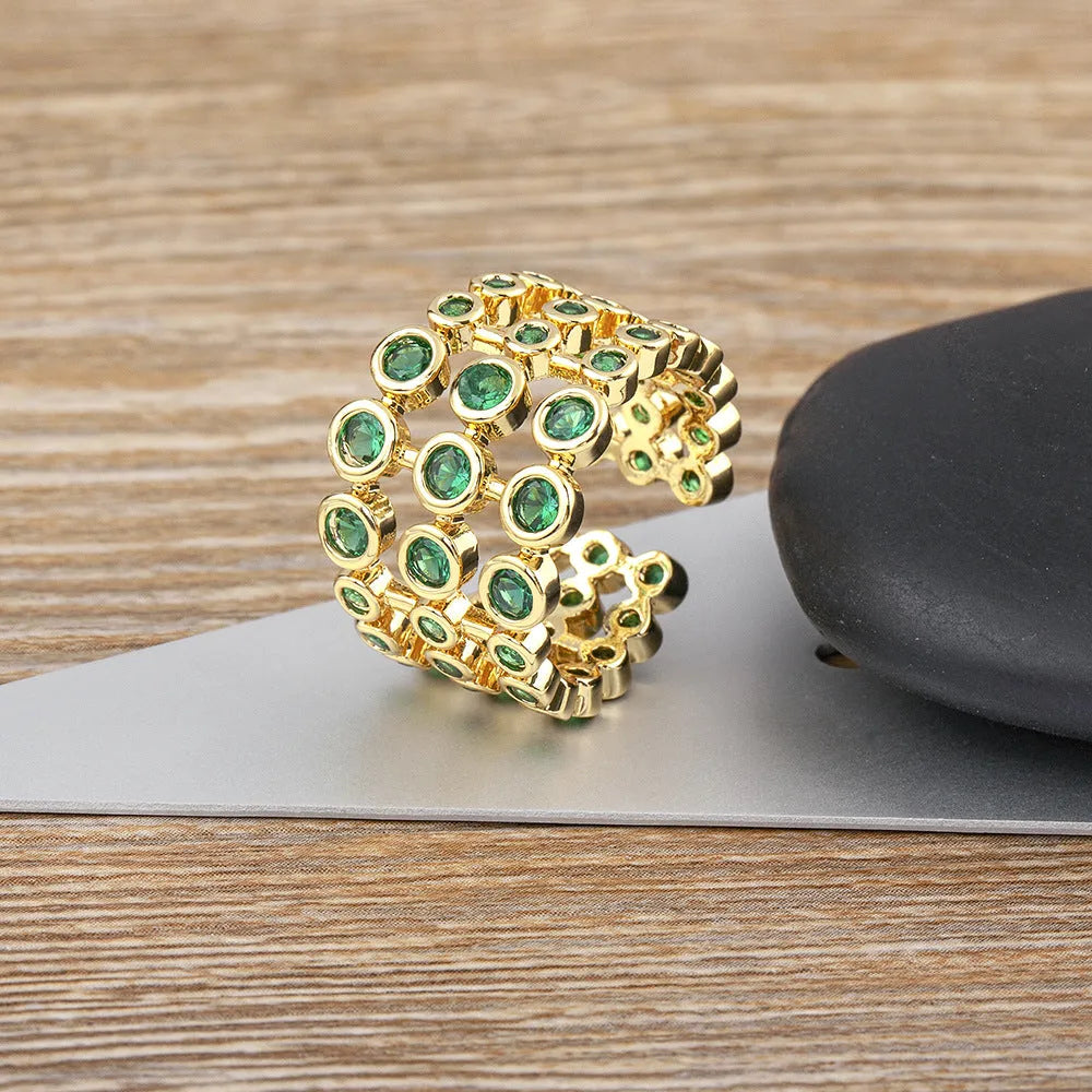 Wide gold-plated copper ring with a large cluster of green zircon stones.