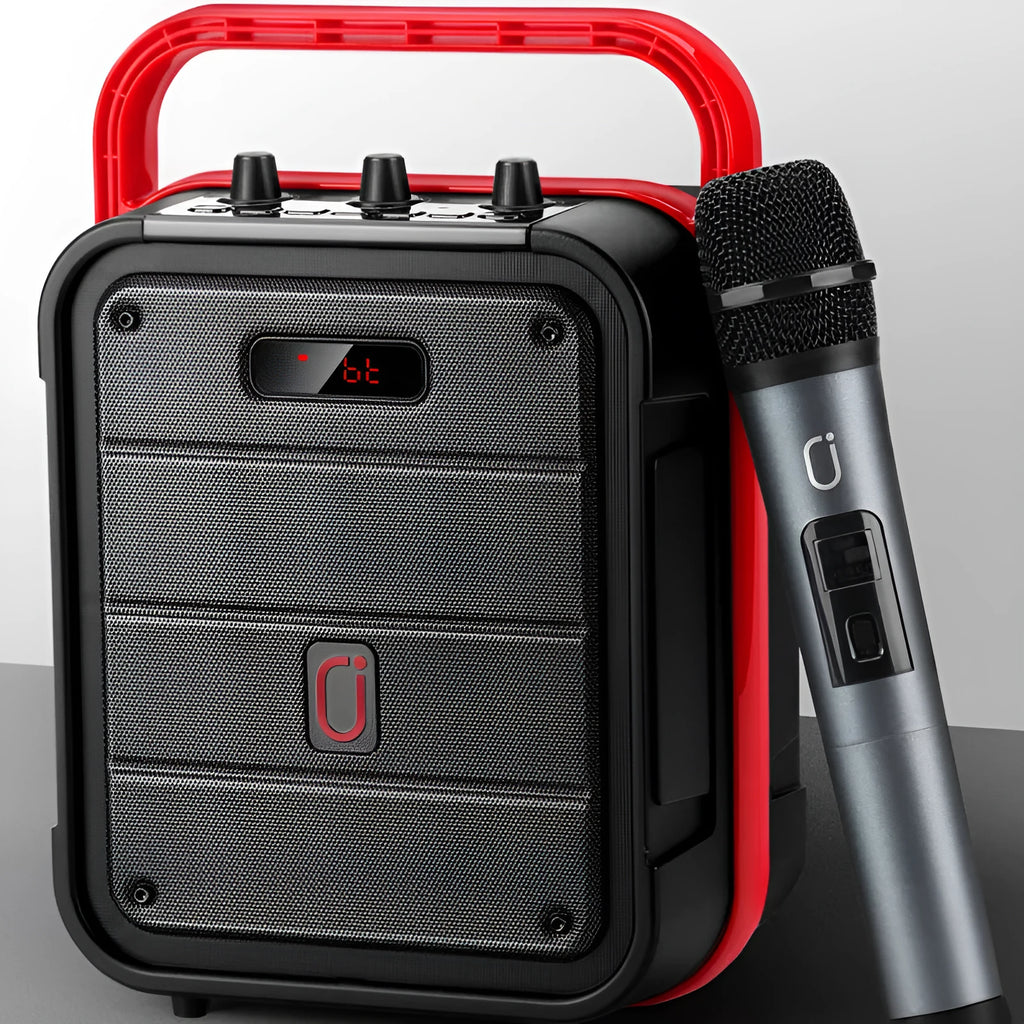 Portable black Bluetooth speaker with a wireless microphone, remote control, and carry strap.