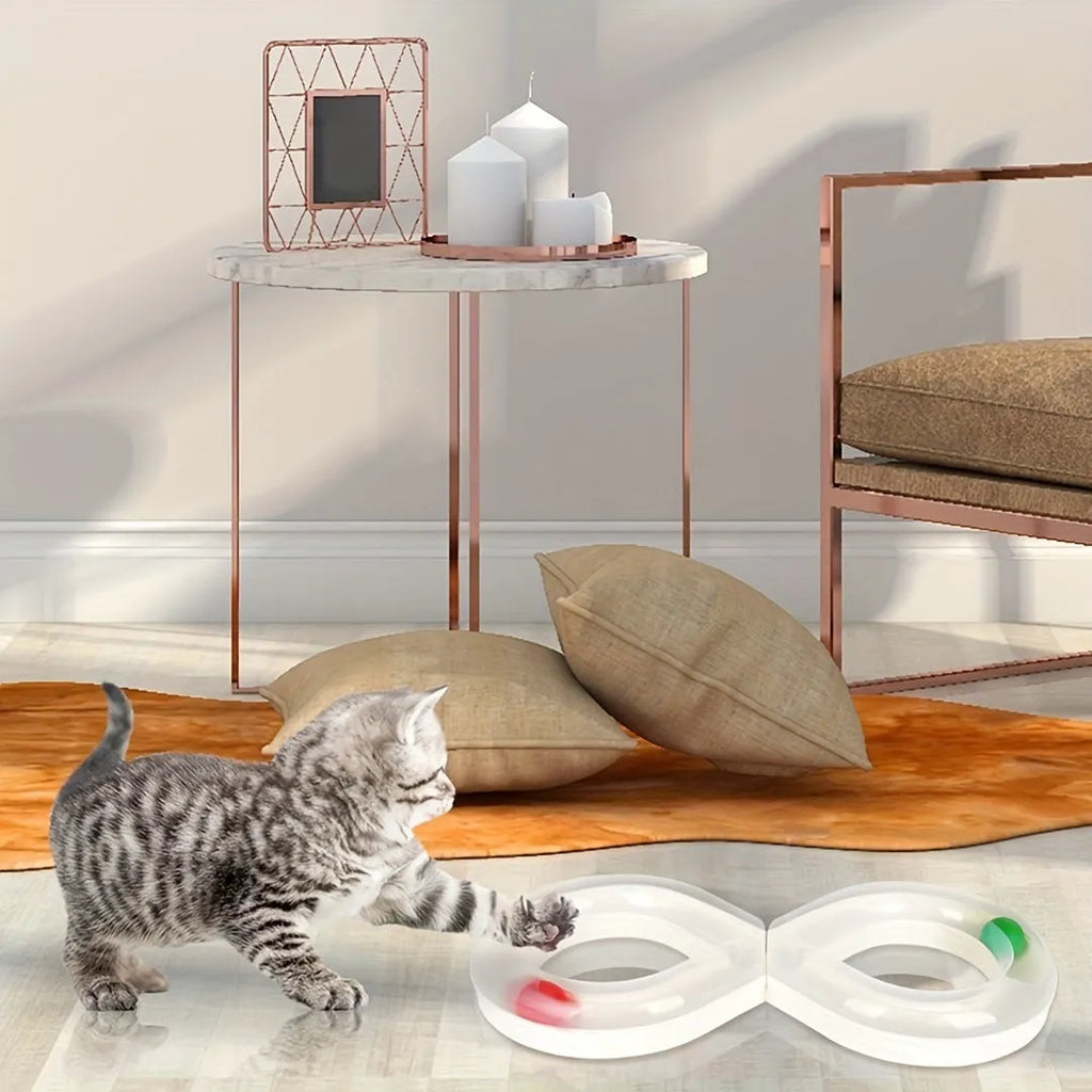 Blue and white plastic cat turntable track ball toy with a teasing stick on a flat surface.