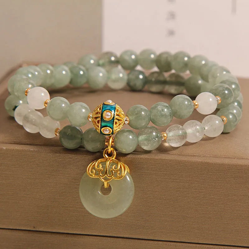 Women's double-layer aventurine jade bracelet in oil green with a safety buckle and rhinestone details.